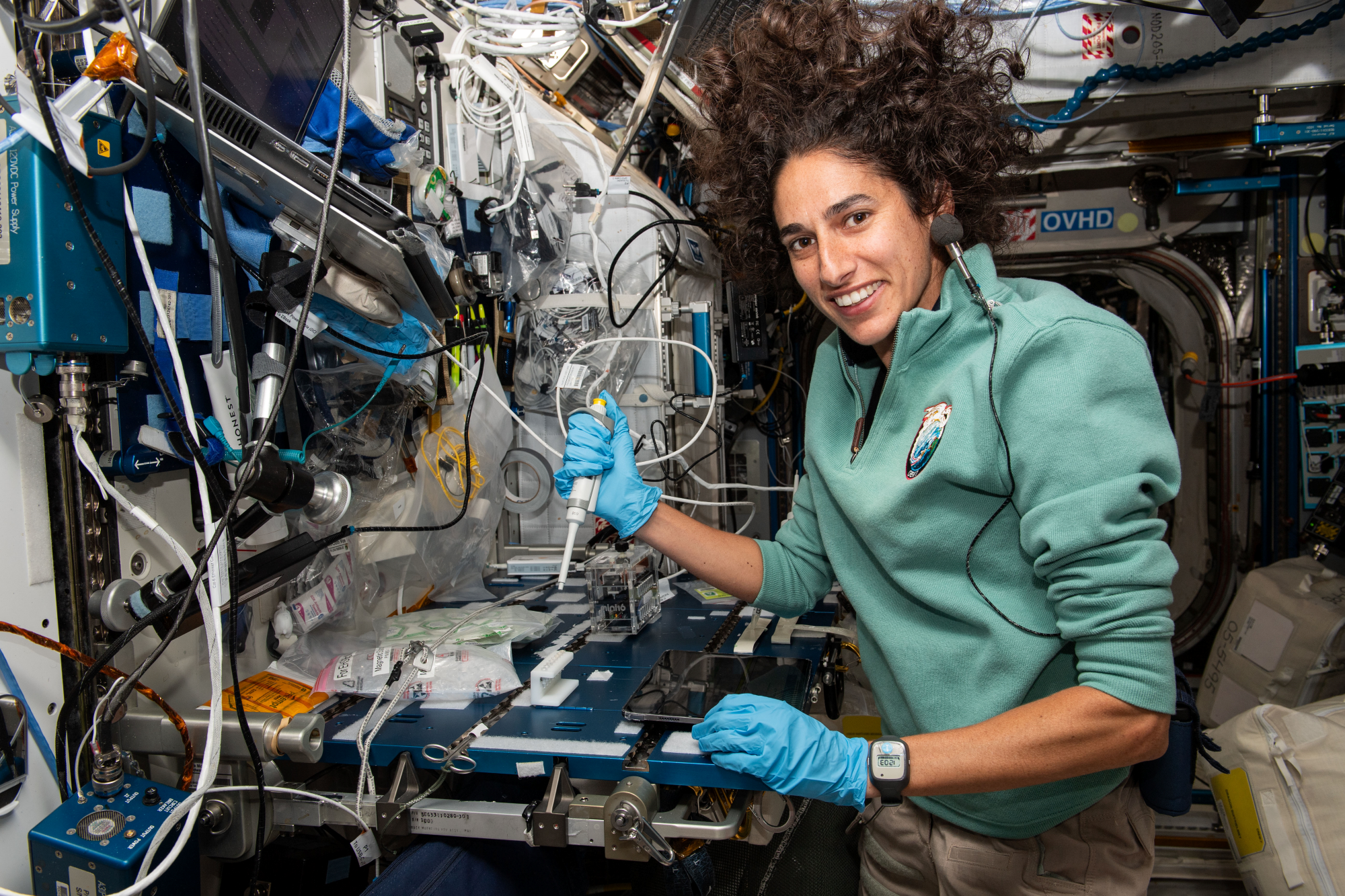 NASA astronaut Jasmin Moghbeli services microbe samples for DNA sequencing aboard the International Space Station.