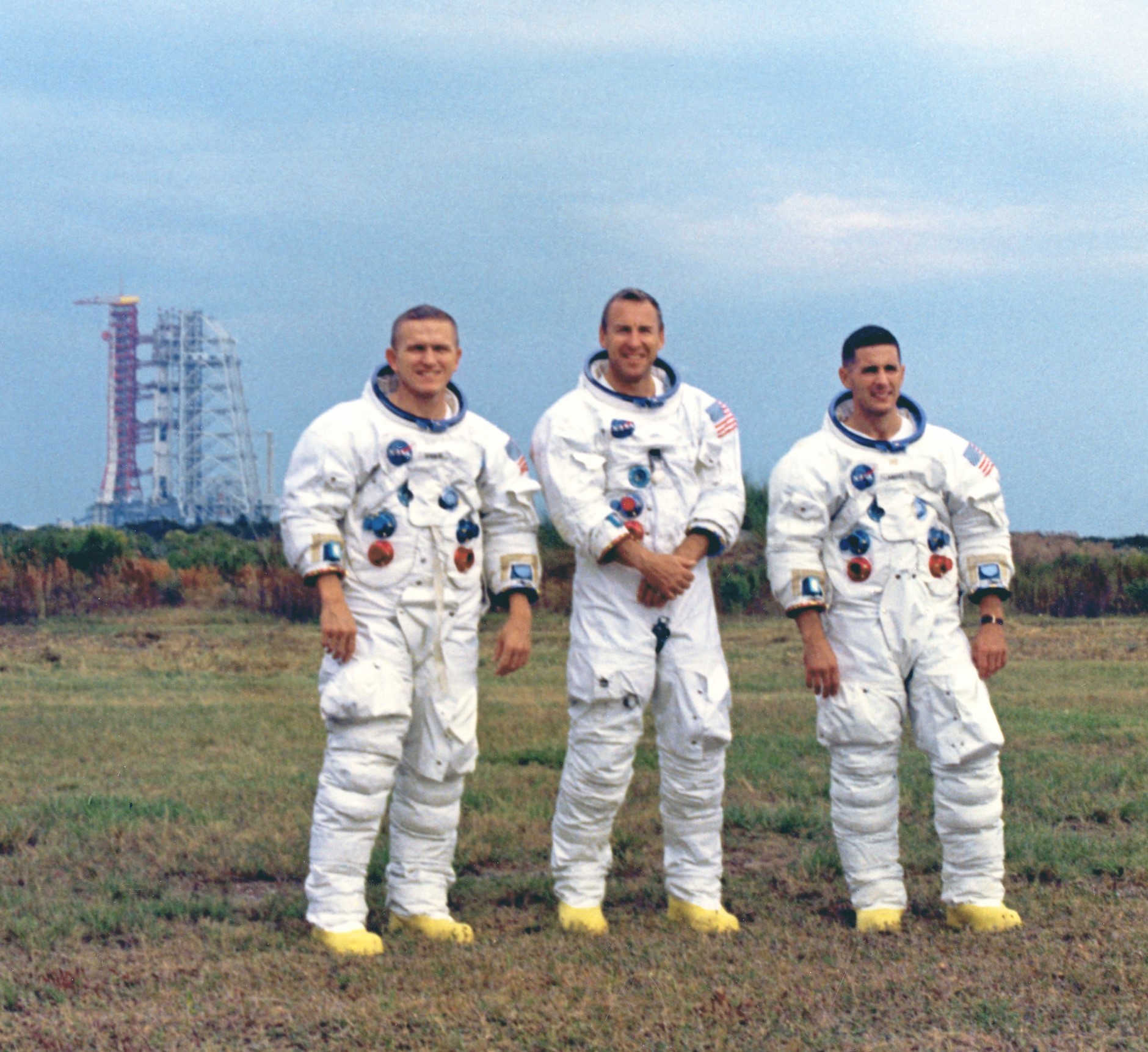 Borman, left, Lovell, and Anders pose with their Saturn V