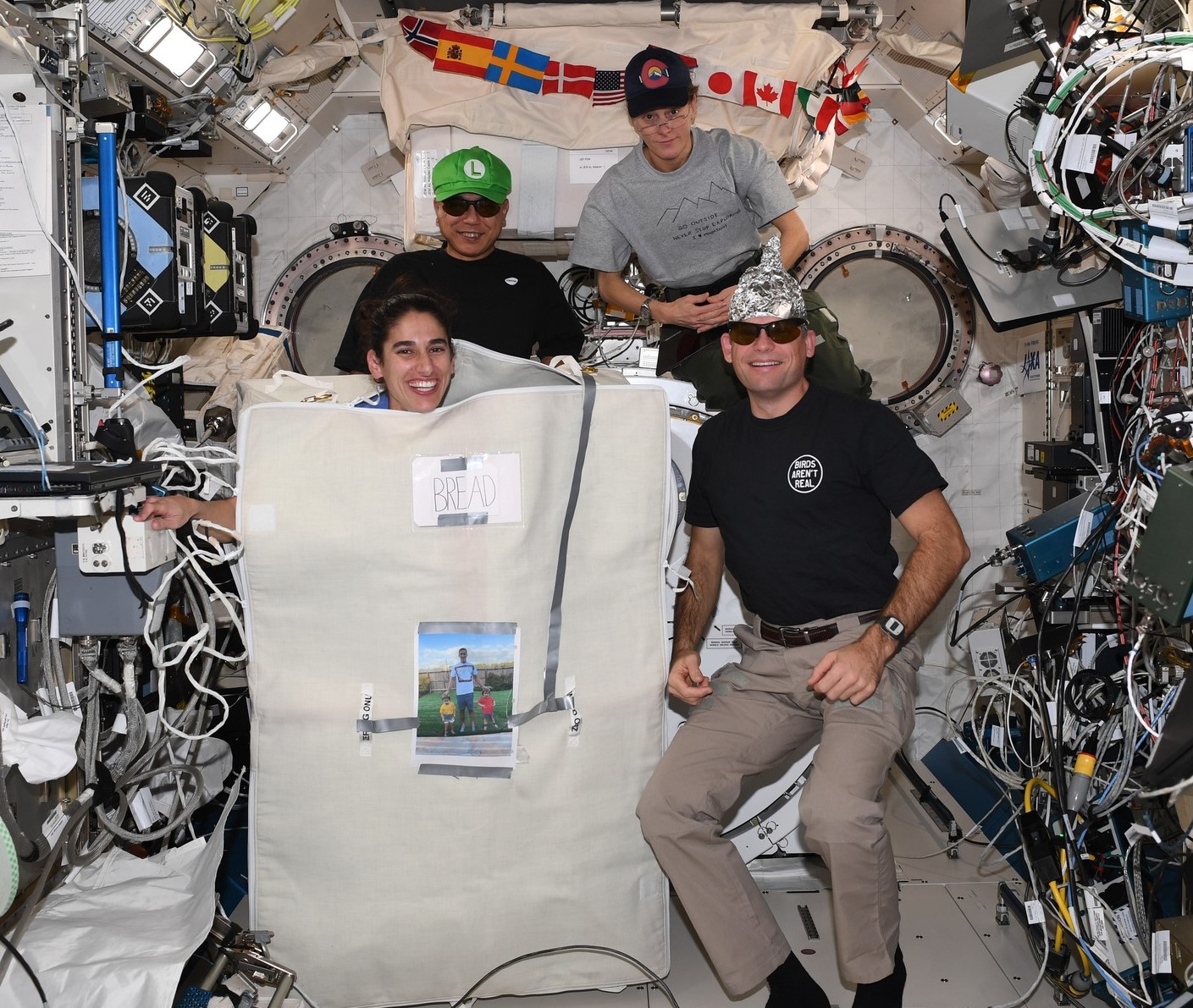 Expedition 70 astronauts Jasmin Moghbeli of NASA, left, Satoshi Furakawa of the Japan Aerospace Exploration Agency, NASA astronaut Loral O’Hara, and European Space Agency astronaut Andreas Mogensen celebrate Halloween 2023