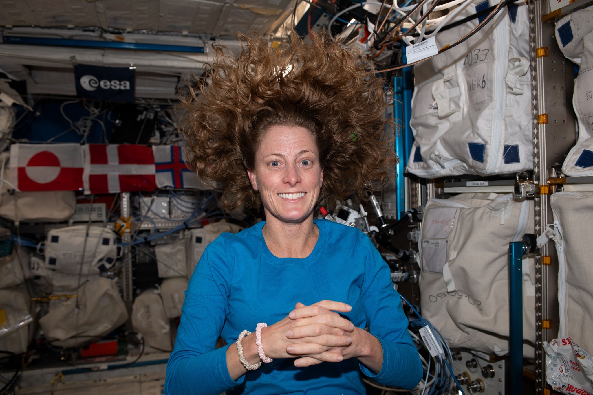 iss070e000668 (Sept. 30, 2023) -- NASA astronaut and Expedition 70 Flight Engineer Loral O'Hara poses for a photo after receiving her first haircut in microgravity.