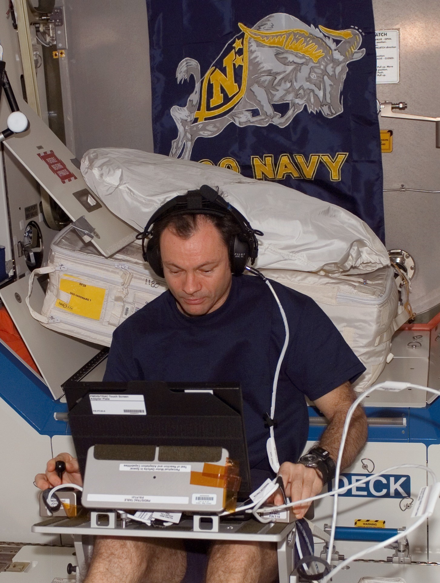 NASA astronaut Michael E. Lopez-Alegria conducting a session of the Canadian TRAC experiment in the Destiny module