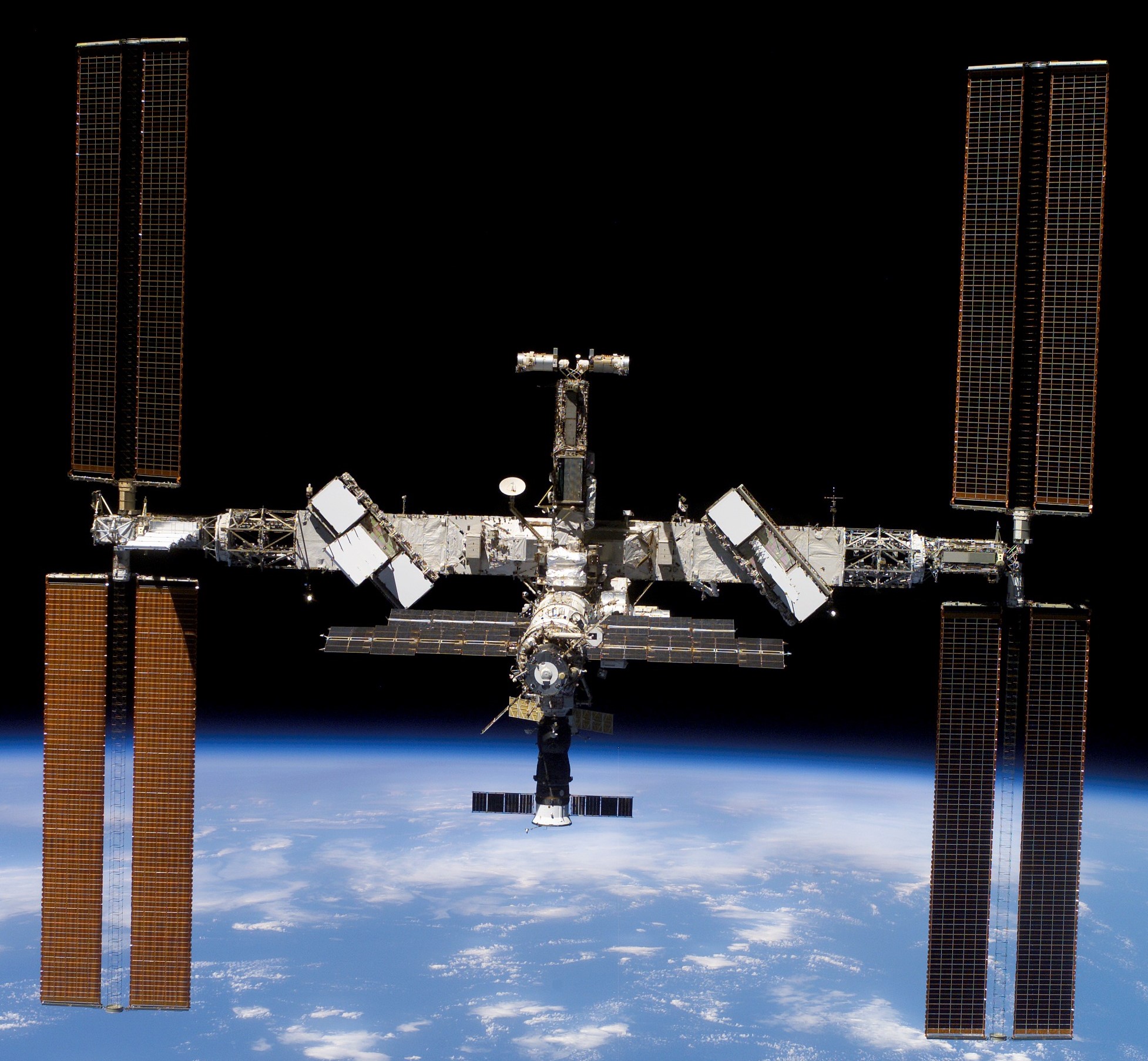 The space station as seen by the departing STS-117 crew, showing the new set of starboard solar arrays at right.