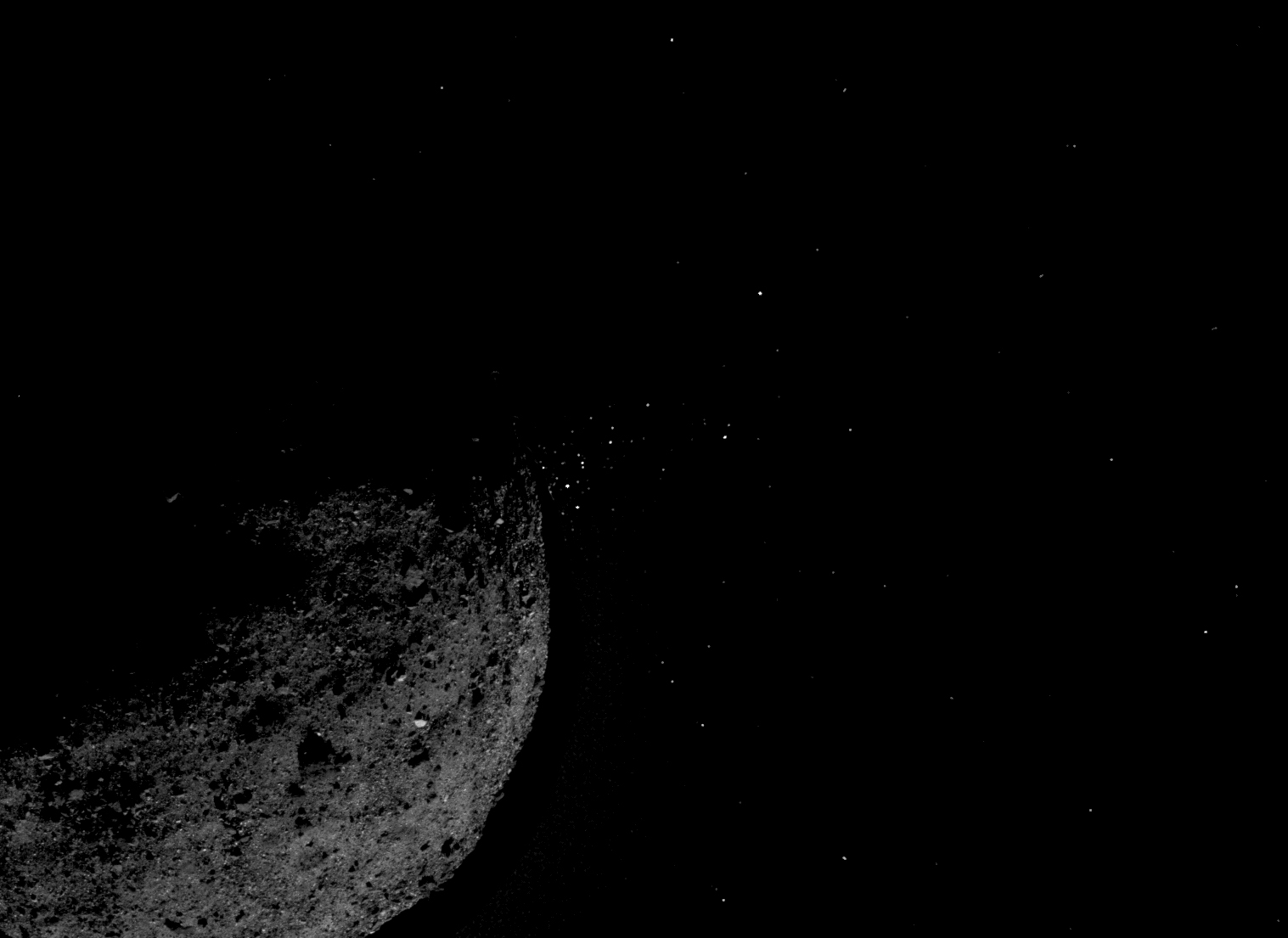 Asteroid Bennu ejecting particles from its surface on Jan. 19, created by combining two images from NASA's OSIRIS-REx spacecraft processed by optical navigation technology