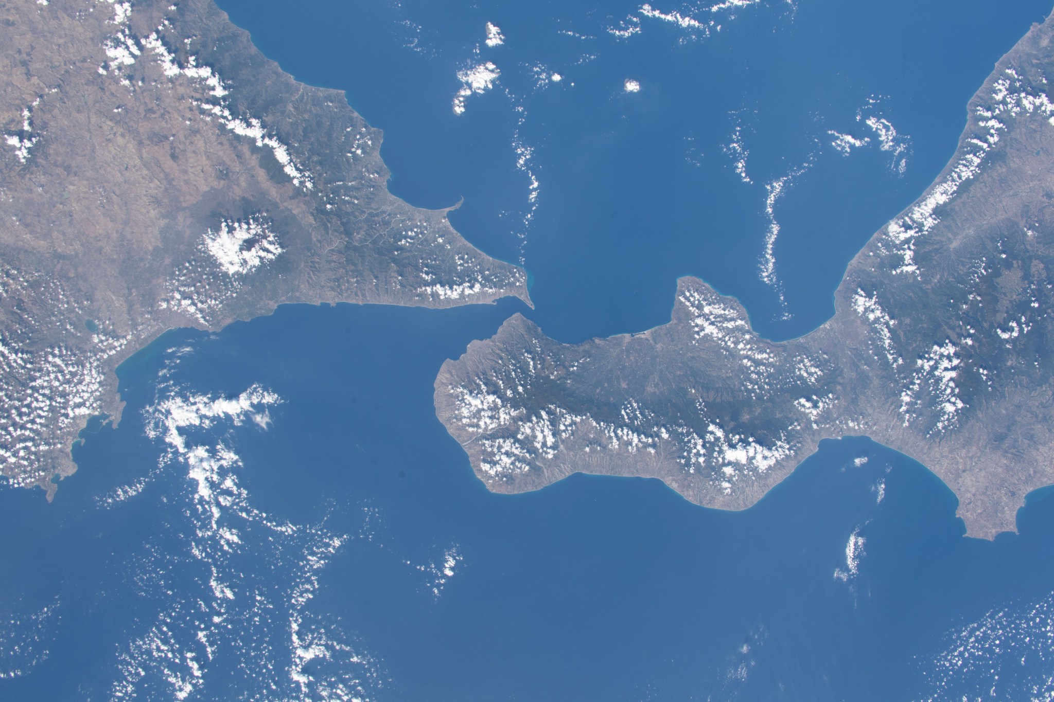 iss070e002586 (Oct. 7, 2023) -- Southern Italy (to the right of the image) meets Sicily (to the left), the largest island in the Mediterranean Sea and one of 20 Italian regions. At its closest point, Sicily resides only 2 miles (~3.2km) from mainland, the two connected by the Strait of Messina. From 260 miles above, the International Space Station offers a unique vantage point of where the two regions meet.