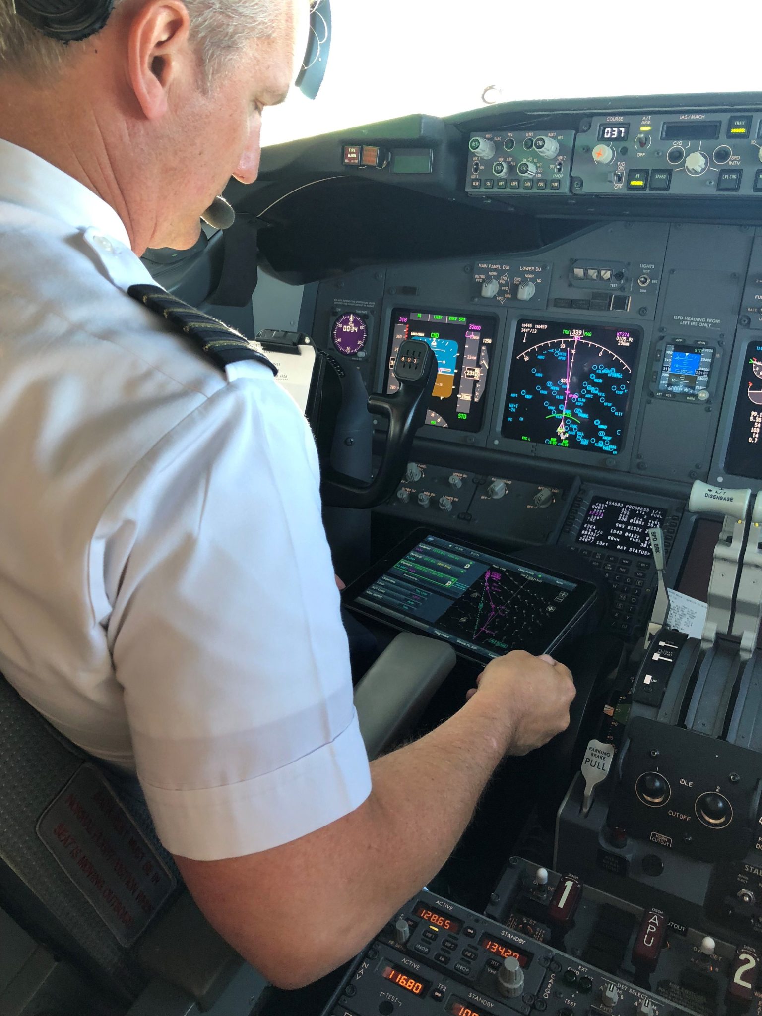 Alaska Airlines Captain Bret Peyton looks at route options presented on an Electronic Flight Bag.