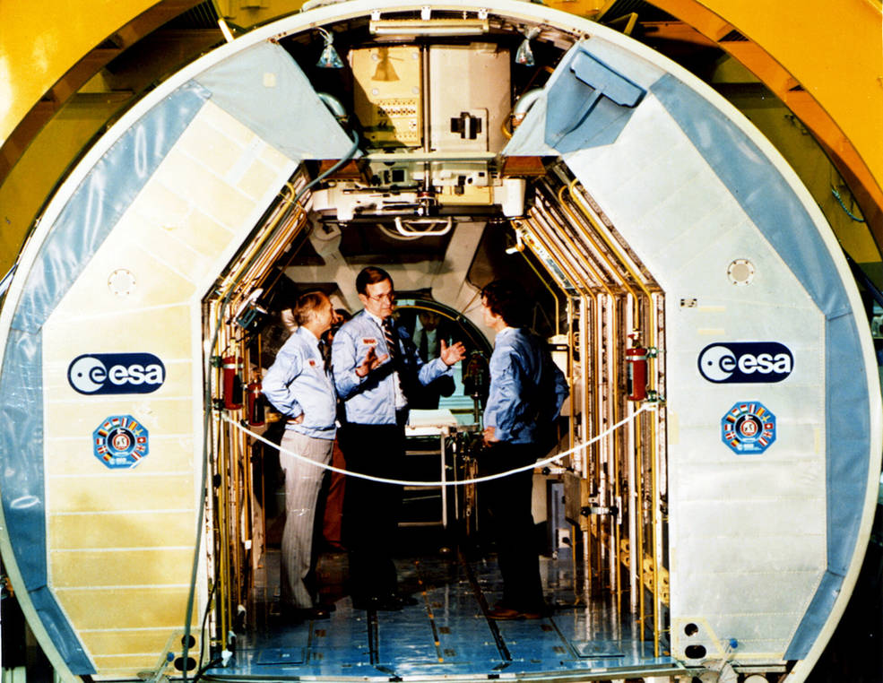 Owen Garriott and Ulf Merbold meet with George H.W. Bush inside Spacelab in 1982
