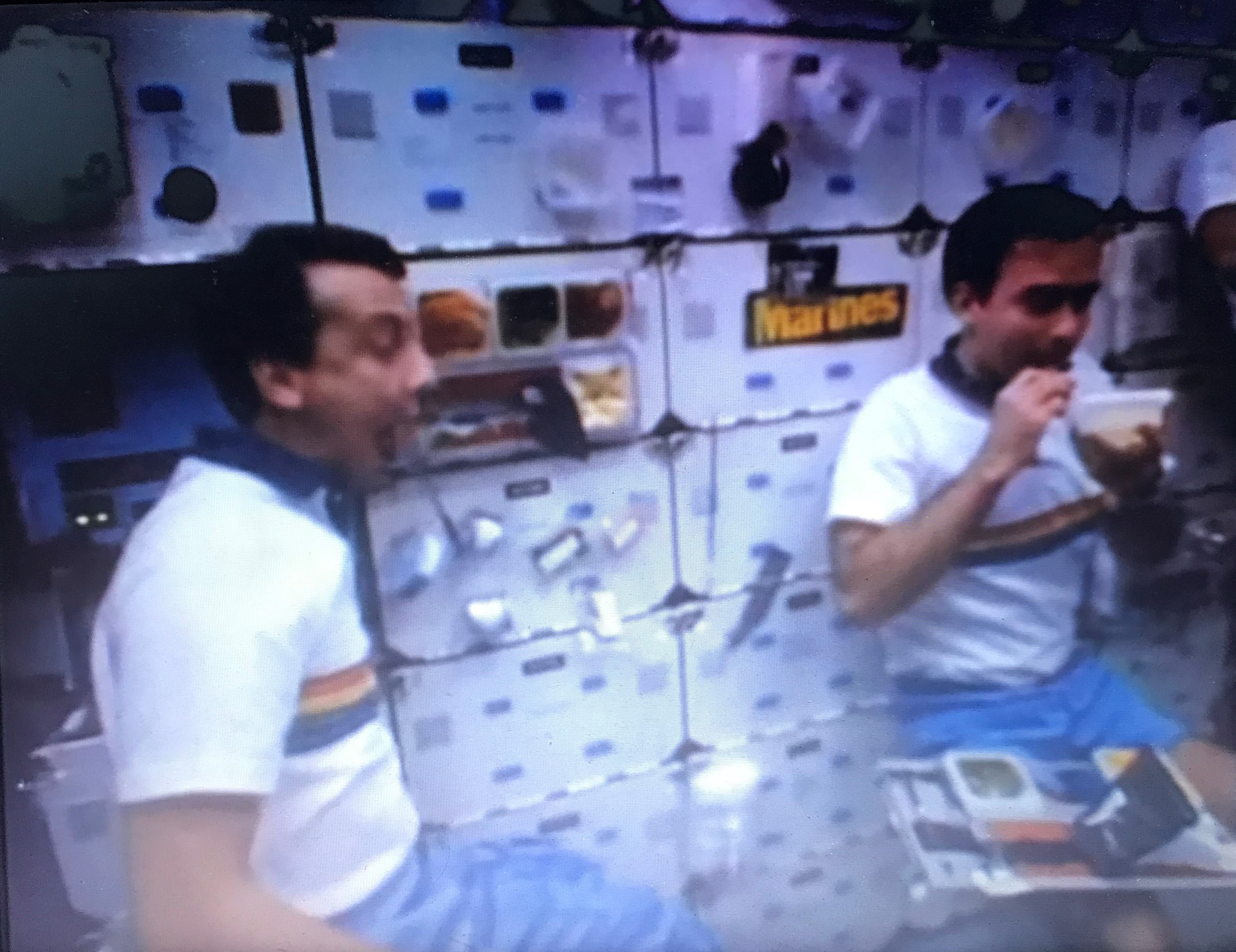 STS-61B payload specialists Charles D. Walker and Rodolfo Neri Vela of Mexico enjoy the first Thanksgiving aboard a space shuttle in Atlantis’ middeck