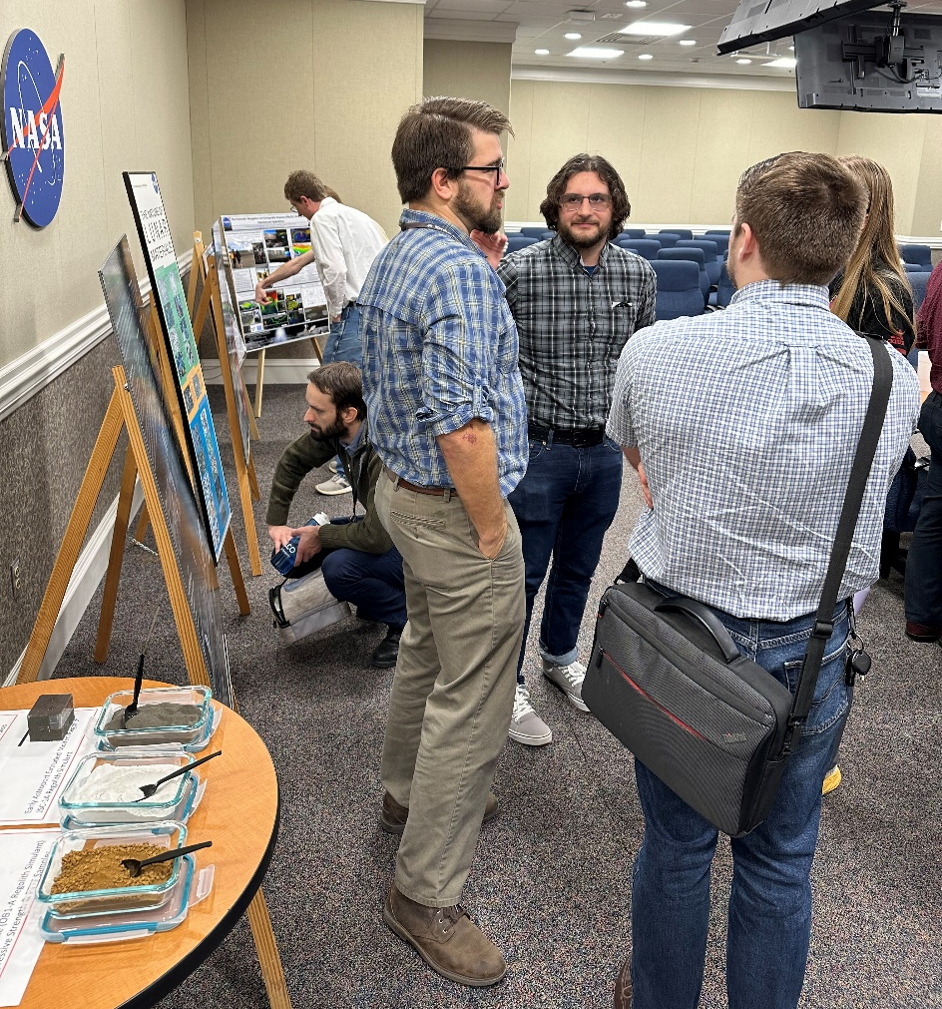 Attendees at Marshall’s first brown bag seminar check out lunar regolith samples, view informational displays, and further discuss the featured topics following the seminar.