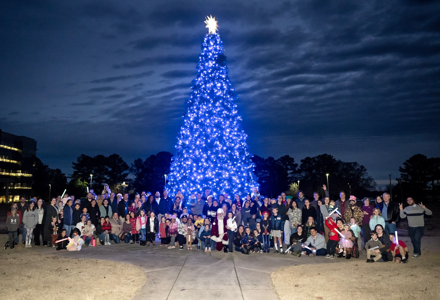 Marshall team members and their family members smile cheerfully as they pose in front of the tree after it was lit. “The holiday season is such a special time for so many people,” Pelfrey said. “To see all the Marshall team members out celebrating with their kids makes for a special day. It was really great to see.”