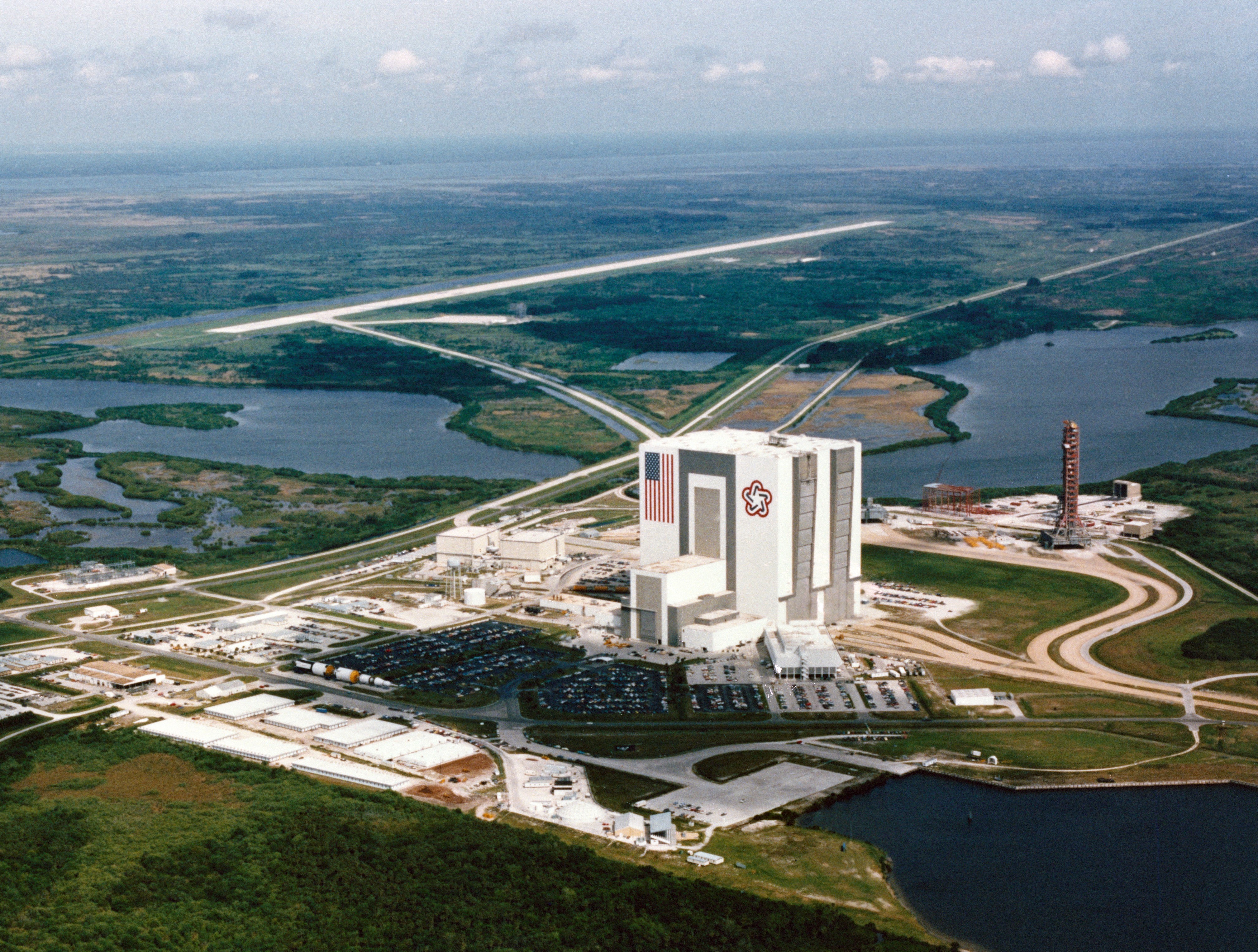 Aerial view at NASA’s Kennedy Space Center (KSC) in Florida of the Vehicle Assembly Building (VAB) and the Shuttle Landing Facility, where STS-41B made the first landing of the program