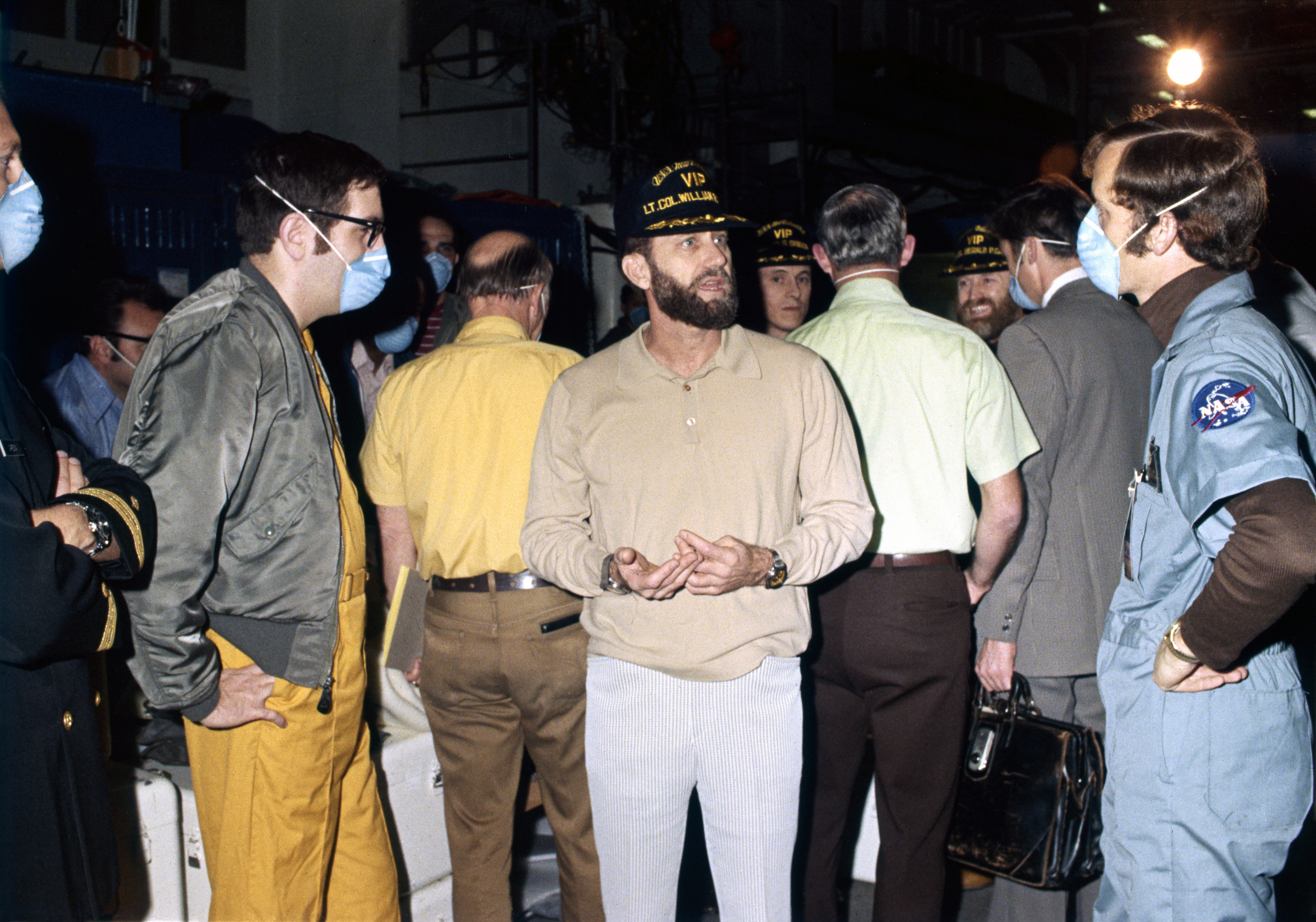 Skylab 4 astronauts mingle with some of the crew aboard the New Orleans