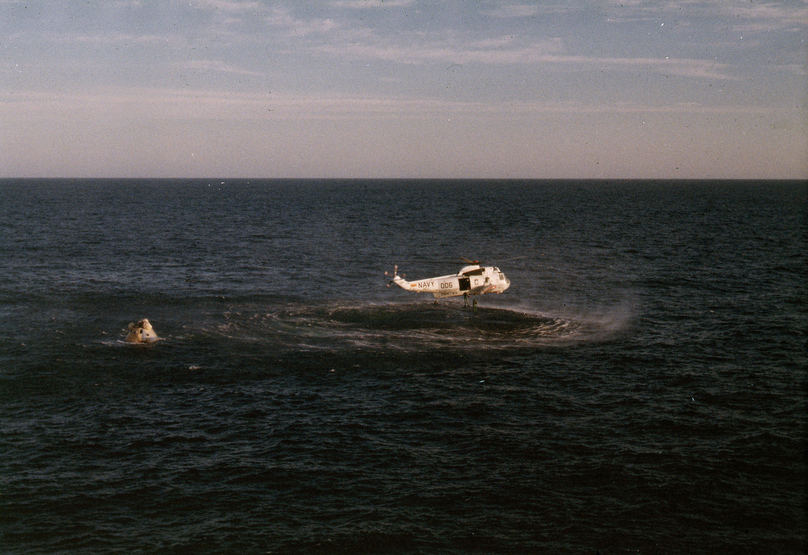 Recovery helicopter from the U.S.S. New Orleans about to drop swimmers into the water