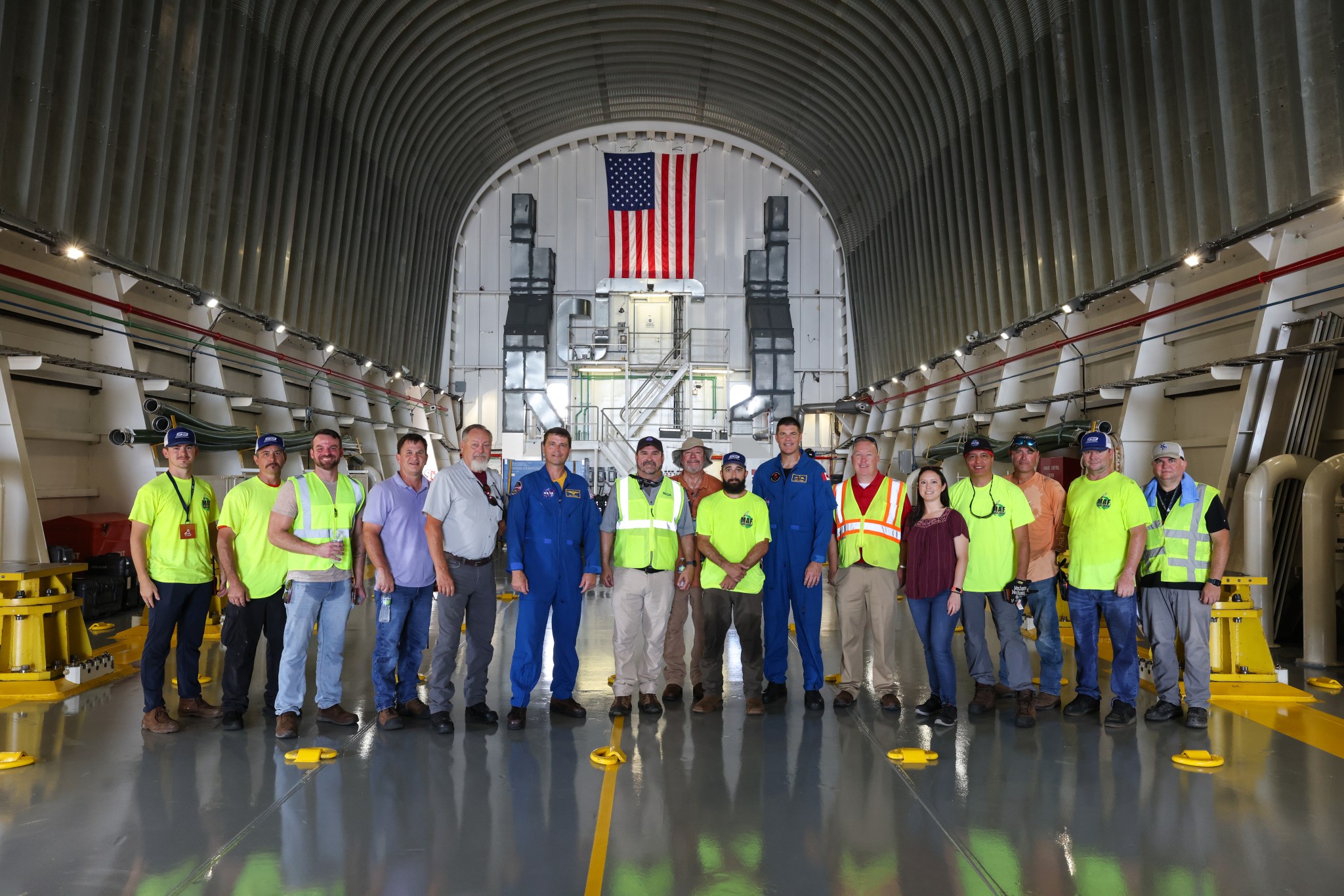 The Pegasus crew and team, from left, includes Kelton Hutchinson, Jeffery Whitehead, Jason Dickerson, Arlan Cochran, John Brunson, NASA astronaut Reid Wiseman of the Artemis II crew, Marc Verhage, Terry Fitzgerald, Scott Ledet, CSA astronaut Jeremy Hansen of the Artemis II crew, Wil Daly, Ashley Marlar, Farid Sayah, Jamie Crews, Joe Robinson, and Nick Owen.