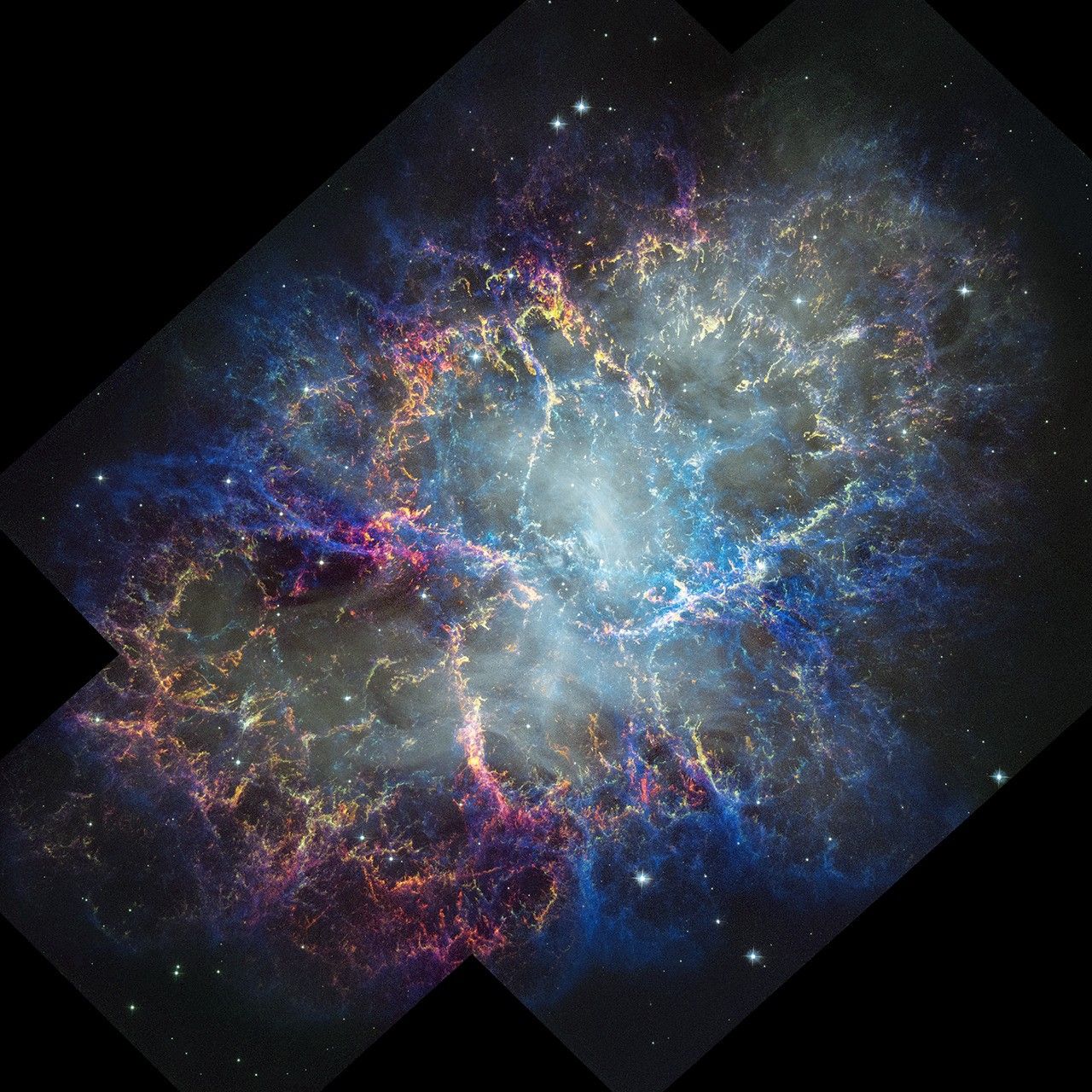 Colorful nebula in space with a white haze throughout that is more concentrated in the center with a rippling effect. Colorful gas filaments appear to splash outward from the nebula center, colored yellow, magenta, and blue. A faint black border with right angles at the corners of the images show where the telescope’s field of view stopsdotted line with right angles shows the borders of the telescope’s image. Small white stars dot the background.
